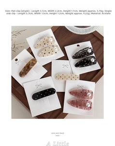 Detail of premium acetate hair clips with inlaid rhinestones and faux pearls on cards