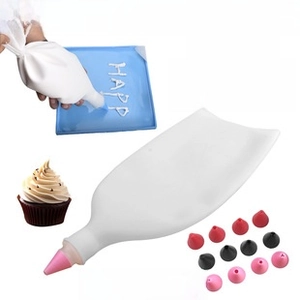 Detail of white silicone pastry bag with interchangeable stainless steel nozzles for baking
