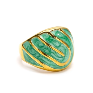 Detailed close-up of vintage gold ring with green enamel inlay and wavy texture