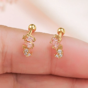 Macro view of gold curved stud earring with pink and white cubic zirconia crystals