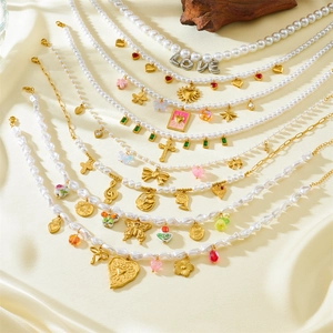 Vintage stainless steel pearl necklaces with heart, bow, and colorful charm pendants