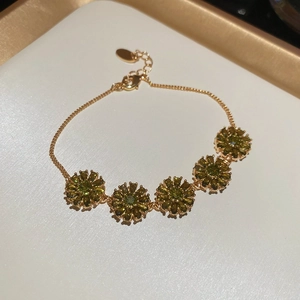 Detail of 18k gold plated flower bracelet with olive green crystals and lobster clasp