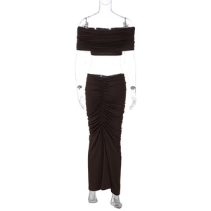 Detail view of the ruched texture on the dark brown bodycon crop top and long skirt set