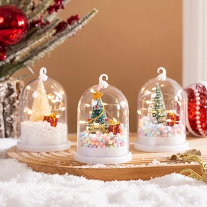 Three mini Christmas snow globe lanterns with LED lights and festive winter scene decor