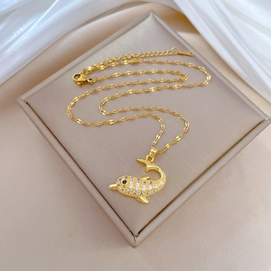 Elegant gold-plated dolphin necklace with sparkling cubic zirconia on a silk background