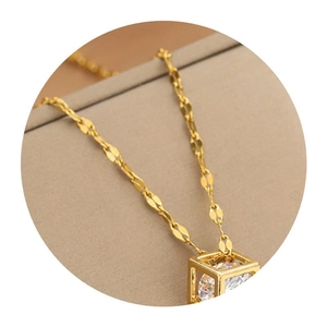 Elegant gold hollow cube pendant necklace with clear cubic zirconia on a ripple chain