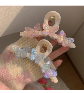 Detailed macro of pink and blue iridescent butterflies on fabric wrapped hair claw clips