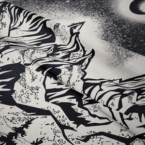 Close-up of black and white mountain forest tapestry showing soft texture and fine printing