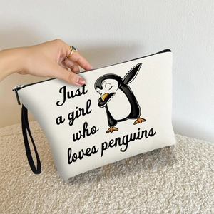 White canvas penguin cosmetic bag with Dabbing cartoon print and black wristlet