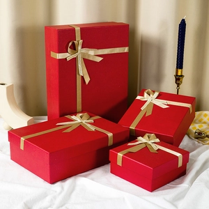 Set of elegant red gift boxes in various sizes with golden ribbons for any festive occasion