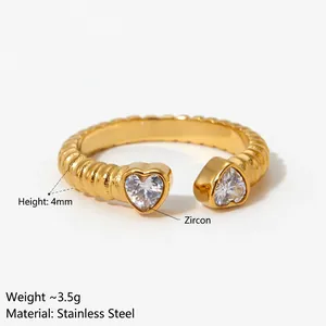 Adjustable gold plated stainless steel ring with ribbed texture and two heart zircons