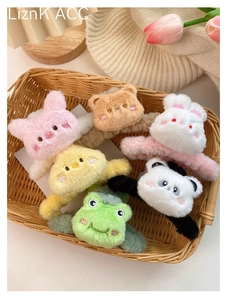 Selection of plush cartoon animal hair claws featuring pig, bear, and panda in a basket