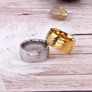 Detailed view of hammered texture stainless steel rings in gold and silver finishes