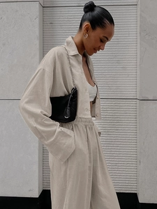 Detail of light beige long sleeve crop shirt and wide leg pants with cotton linen texture
