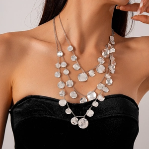 Detail of silver layered necklace with hand-hammered texture and metallic finish