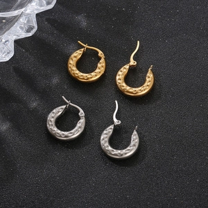 Pair of gold and silver stainless steel hoop earrings with unique hammered texture design