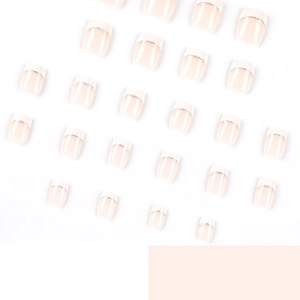 Short French press-on nails with white tips, gold lines, and a soft pink glossy finish