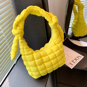 Bright yellow puffy quilted cloud bag with knotted top handle and stylish nylon texture