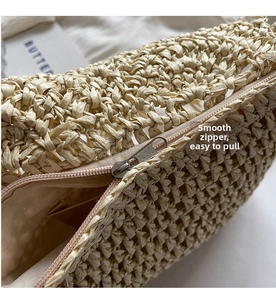 Detail of smooth metal zipper closure and woven texture on this summer straw beach bag