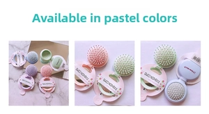 Detail of portable candy-colored folding hairbrush with integrated round mirror and soft bristles