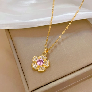 Elegant gold titanium steel flower necklace with pink gemstone and pavé diamonds