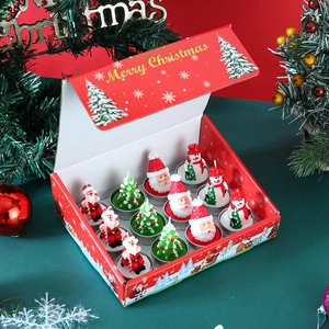 Macro detail of 12-piece Christmas candle set featuring Santa, snowman, and tree shapes