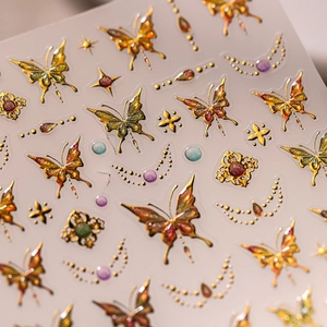 Metallic butterfly nail art stickers with gold foil outline and glitter gradient finish