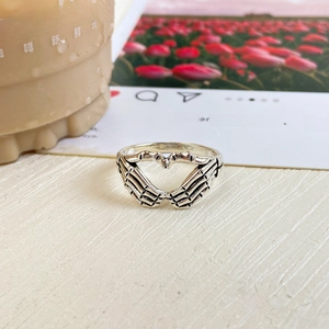 Detail of vintage skeleton hand ring forming a hollow heart with an antique silver finish
