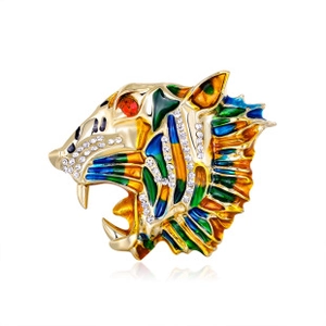 Macro detail of a tiger head brooch featuring colorful enamel and sparkling rhinestones