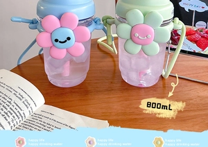 Detail of 800mL water bottle showing cute sunflower lid and adjustable strap