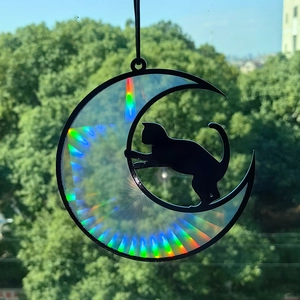 Detailed view of rainbow holographic black cat on crescent moon window suncatcher