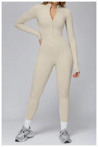 Close-up of a light beige long-sleeve thermal yoga bodysuit with half-zip and stand collar