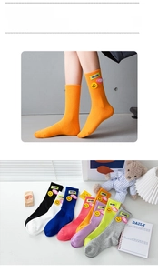 Detail of candy-colored ribbed mid-calf socks with smiley face patches and letter tags