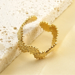 Detailed view of 18k gold plated stainless steel open ring with sunburst gear design
