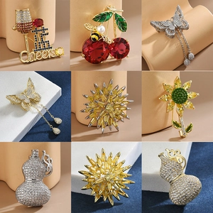 Variety of creative brooches featuring sunflowers, butterflies and cherries with rhinestones
