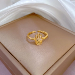 Hamsa hand gold open ring with sparkling white cubic zirconia stones on silk