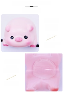 Detail view of pink resin pig ornament featuring strong adhesive backing and traceless removal