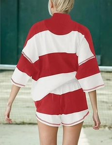 Rear view of striped short sleeve top and matching shorts on a green tennis court