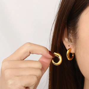 Elegant 18K gold plated stainless steel C-shape hoop earrings on a female model