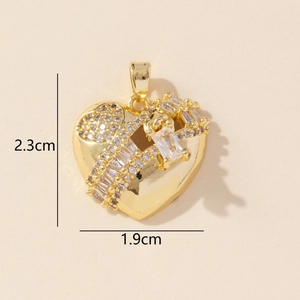 Close-up of golden heart pendant with cubic zirconia and dimension markings