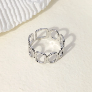 Macro view of silver geometric open ring showing polished stainless steel texture