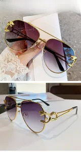 Detailed view of luxury gold leopard head accent on aviator sunglasses temple