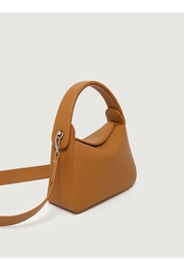 Detailed close-up of brown litchi pattern leather handbag with silver metallic hardware