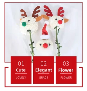 Macro detail of Christmas themed flower arrangements with reindeer antlers and santa hat