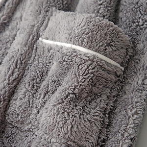Thick grey coral fleece bathrobe featuring a pocket with white piping and soft texture