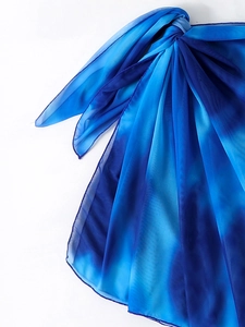Detail of blue gradient semi-transparent beach cover-up fabric showing texture