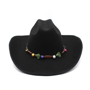 Detailed view of black felt cowboy hat with colorful ethnic pattern decorative band