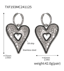 Detail showing oversized stainless steel heart earrings with oil drip edge and hammered texture