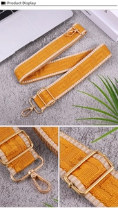 Macro shot of ethnic geometric jacquard bag strap with gold metal lobster clasps