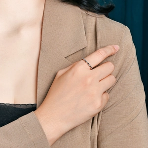 Minimalist French braided rope ring in silver finish worn on finger for fashion look